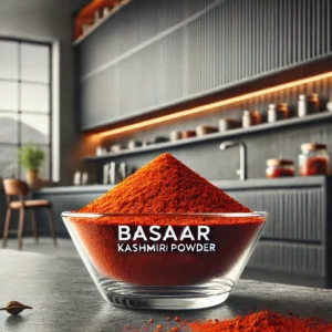 A vibrant dish of freshly blended Kashmiri Basaar spice mix featuring ground aromatic seeds, sweet paprika, and turmeric, beautifully arranged to show its rich crimson color.